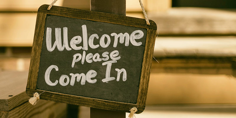 Handwritten sign that reads, "Welcome, please come in"